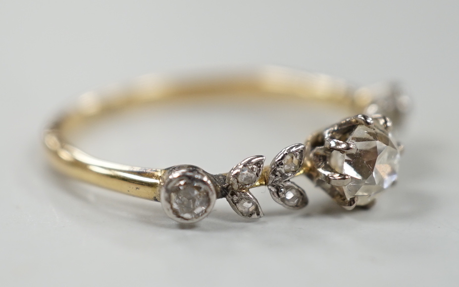 An 18ct and diamond cluster set half hoop ring, of foliate design, size N, gross weight 2.3 grams.